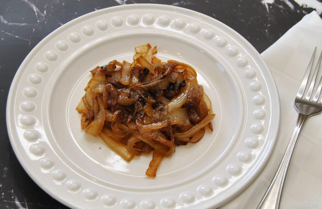 White plate with caramelized onions in middle