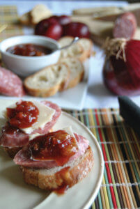 Asian Plum-Onion Chutney dip on a a cracker with sausage