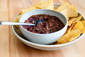 Charred Red Onion Salsa in bowl with chips