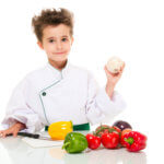young chef holding onion