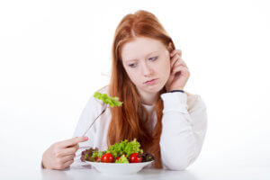 Girl with fork in salad