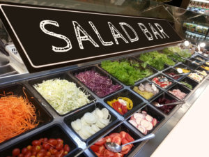 variety of fresh colorful vegetable and fruit at salad bar corner in
