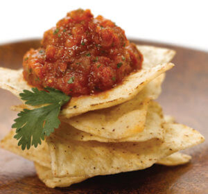 Charred Tomato n Onion Salsa on stack of tortilla chips