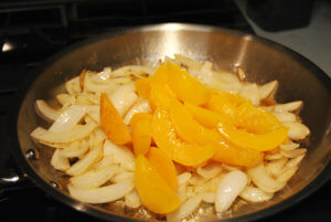 Onions and peach slices in sliver pan