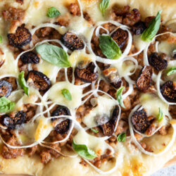 Flatbread with sausage, fig and onion on white background