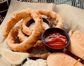 Paw-Paw's Onion Rings with ketchup and sandwich