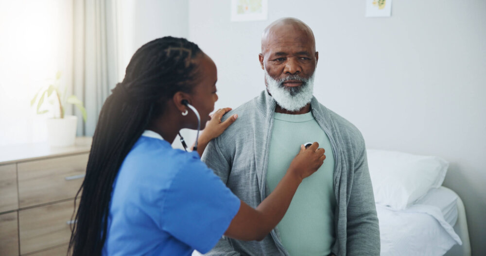 Doctor checking man's heart. Photo Credit: Jacob Wackerhausen