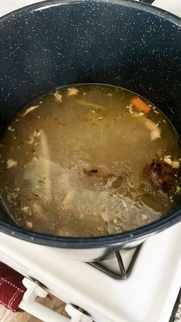 Homemade chicken broth in pot