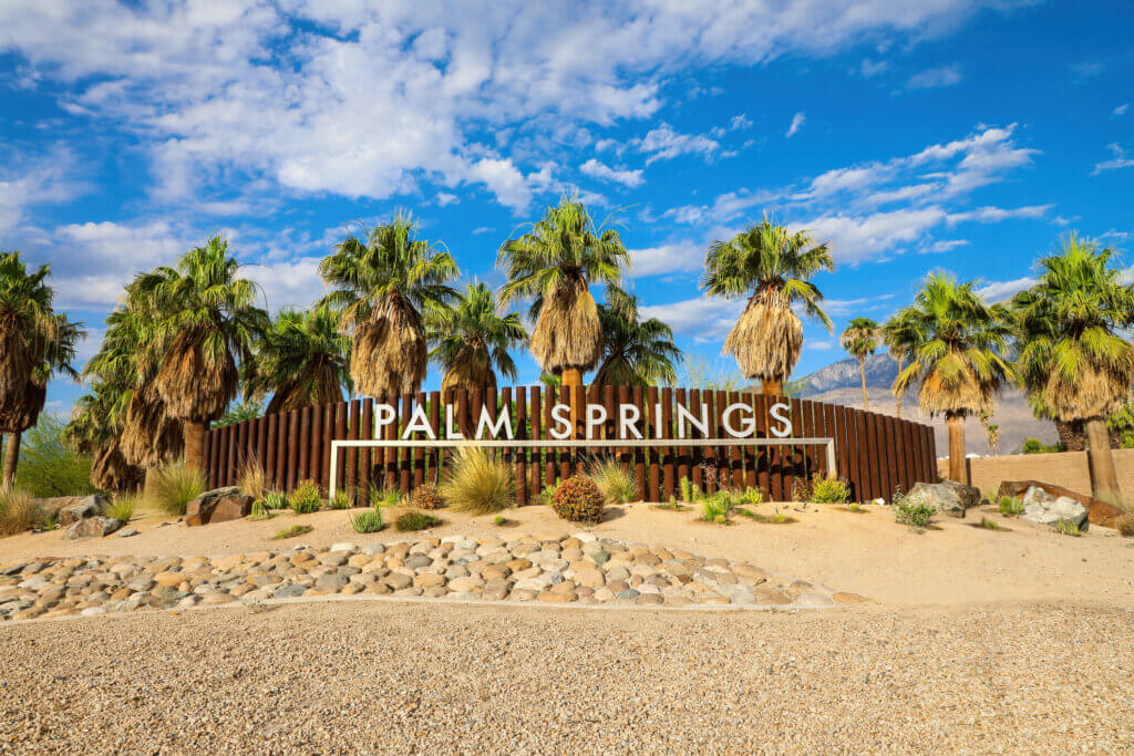 Photo fo Palm Springs  sign with palm trees